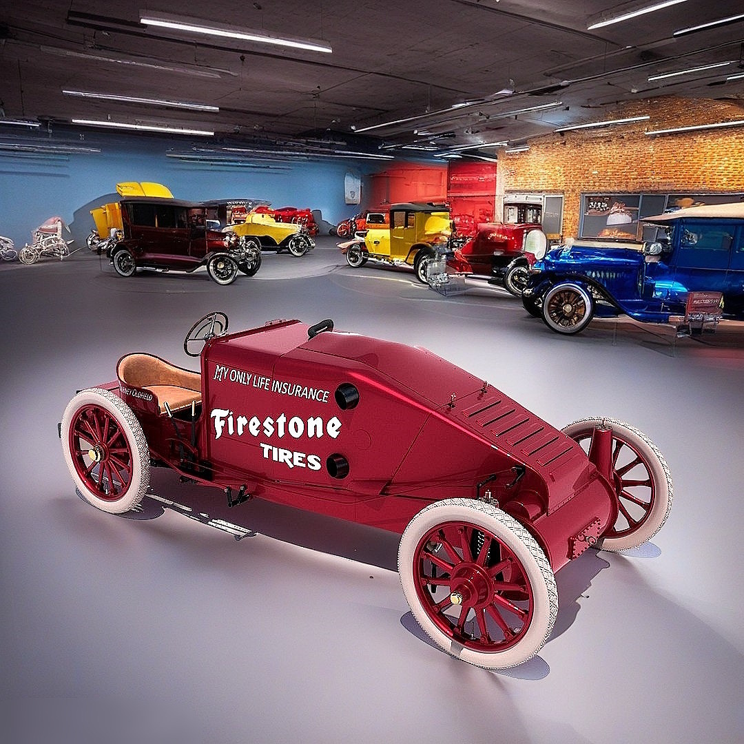 Red 1909 Christie V-4 racing car with Firestone branding in vintage automobile museum