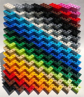 Isometric view of LEGO bricks arranged in rainbow color gradient grid pattern
