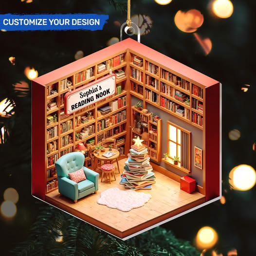 Miniature reading room ornament with bookshelves, blue armchair, and a small Christmas tree