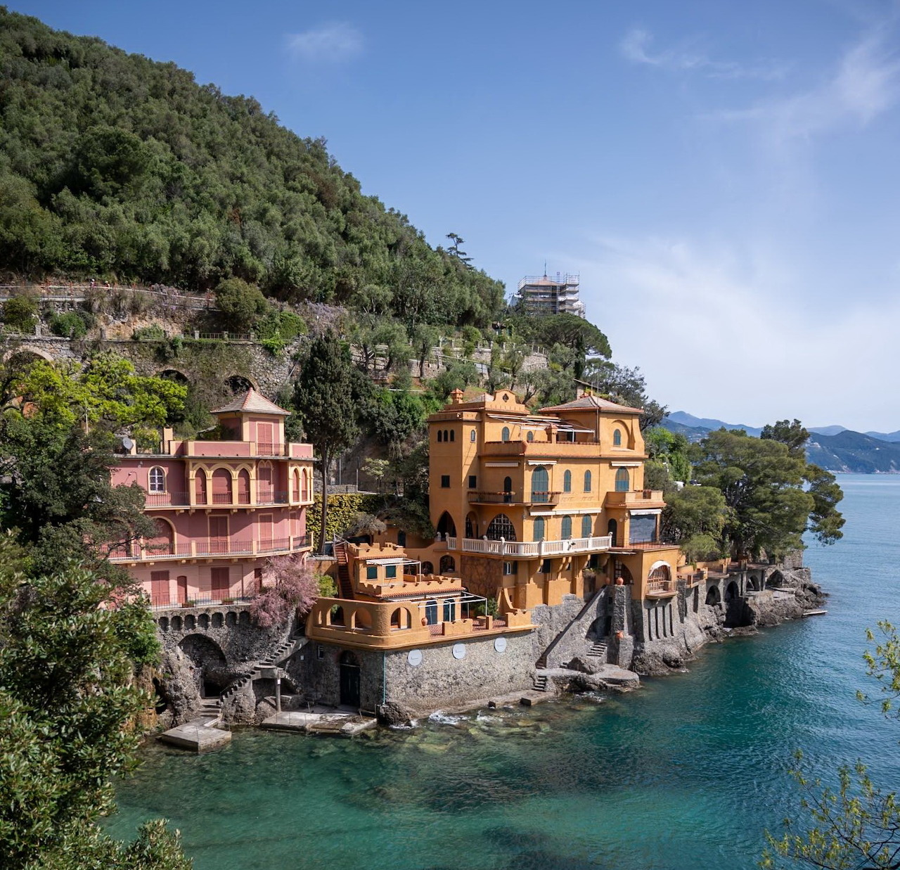 Portofino Italy coastal village with orange buildings on hillside overlooking turquoise Mediterranean sea
