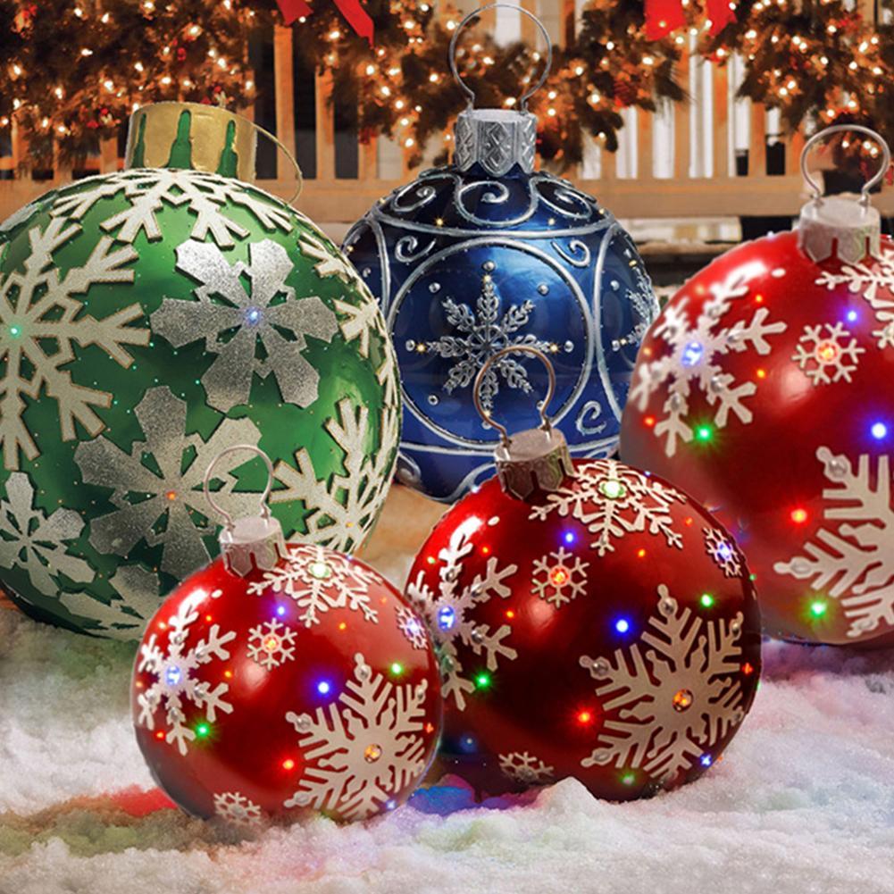 Red, green, and blue Christmas ornaments with snowflake patterns on artificial snow