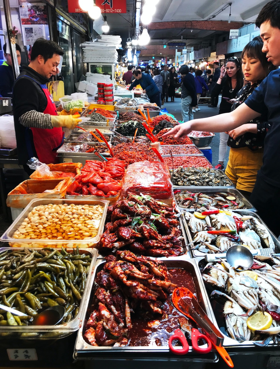 Fresh seafood including fish, shrimp and shellfish displayed on ice at a market