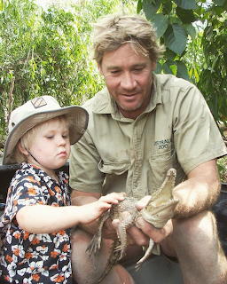 Steve Irwin and young son Robert holding a baby crocodile together outdoors