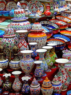 Colorful collection of hand-painted Turkish ceramic vases, bowls, and plates with intricate patterns