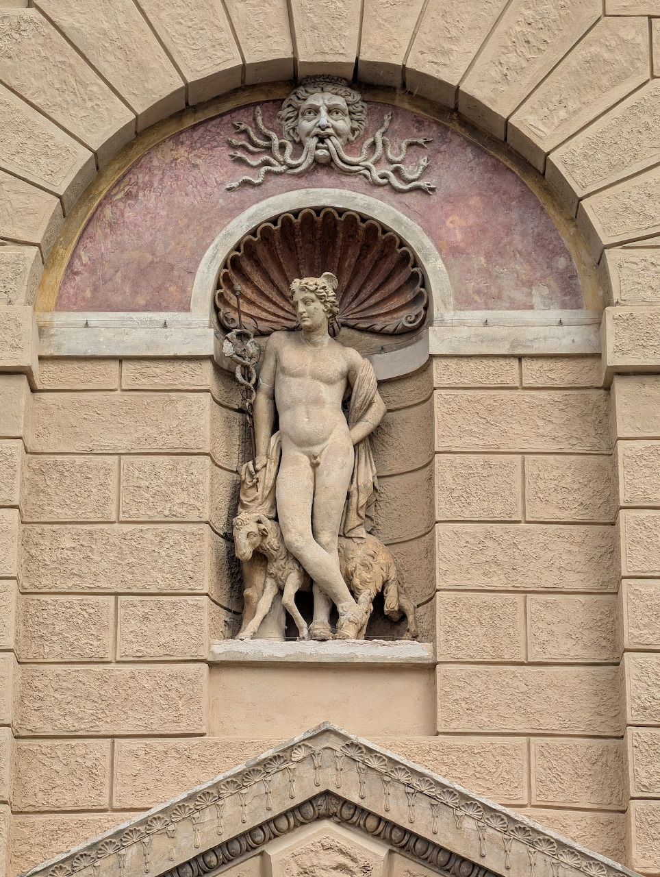 Renaissance facade of Casa di Giulio Romano in Mantua with arched windows and rusticated stonework