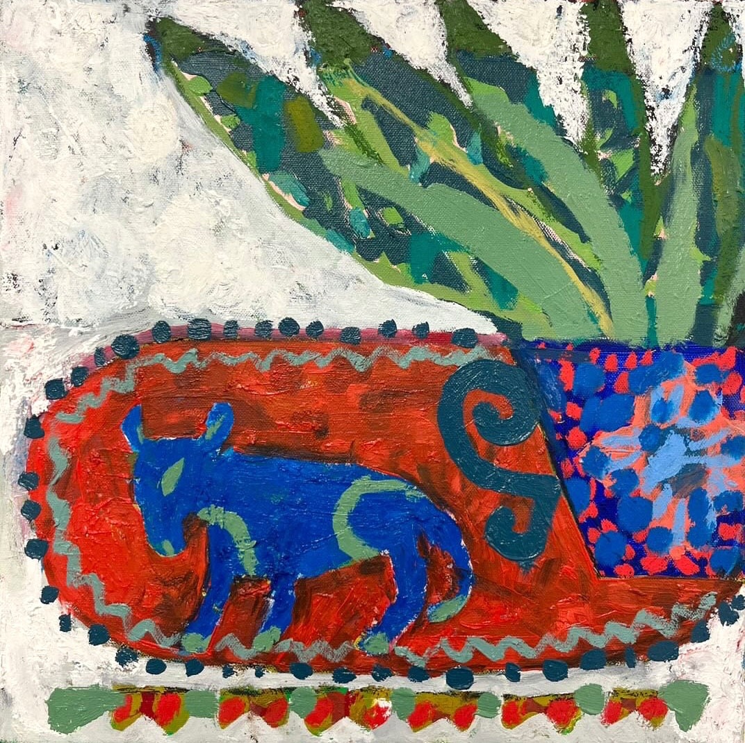 Naive folk art painting of a blue calf on red decorative base with green plant leaves and colorful patterns