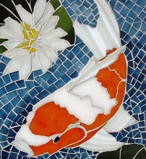 Mosaic art of orange and white koi fish with lotus flower on blue tile background