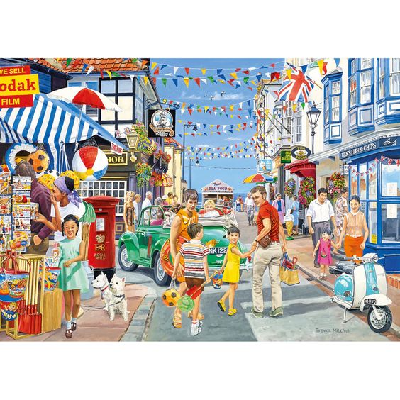 Busy seaside town street with shops, people, bunting, and vintage cars