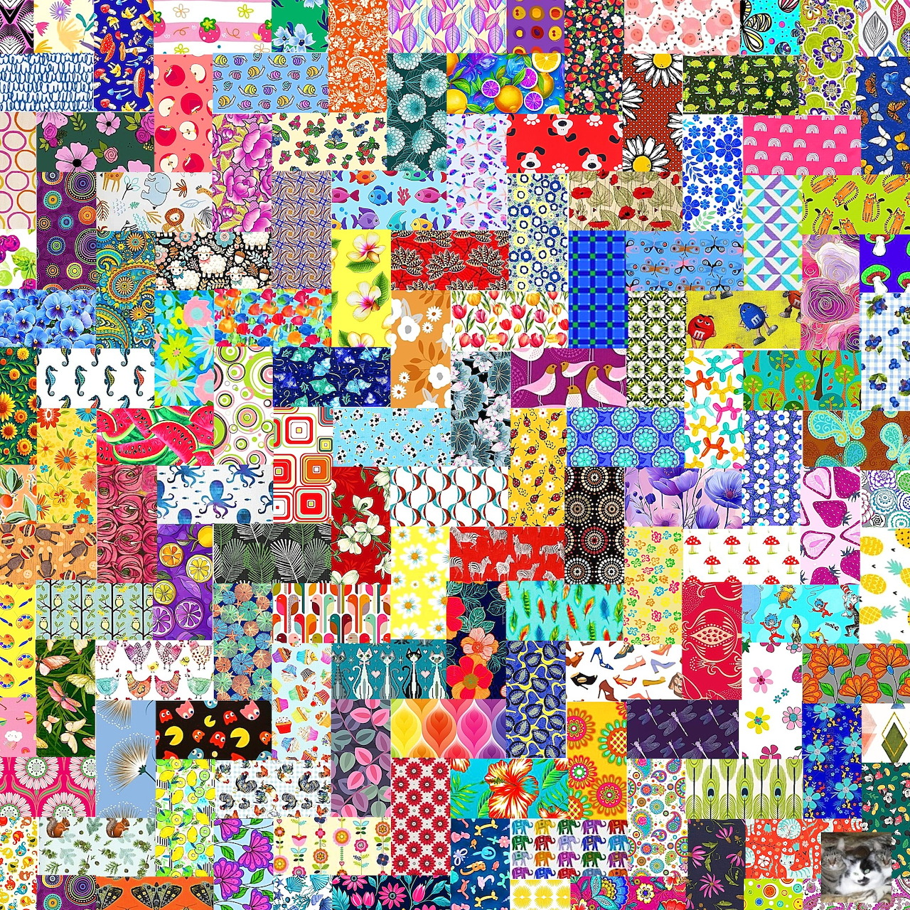 Colorful patchwork quilt made of many different fabric patterns and designs arranged in a grid