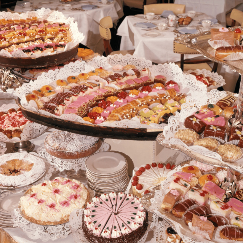 Abundant dessert buffet with cakes, tarts and pastries decorated with fruit and powdered sugar