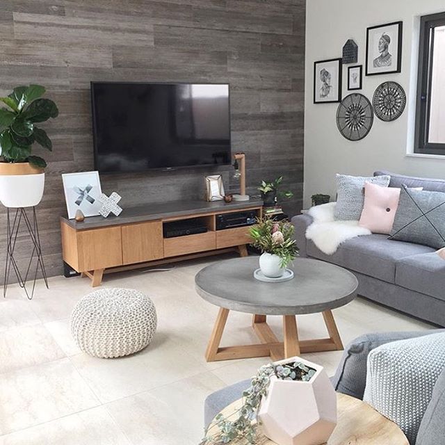Modern living room with gray sofa, wooden furniture, and minimalist Scandinavian decor