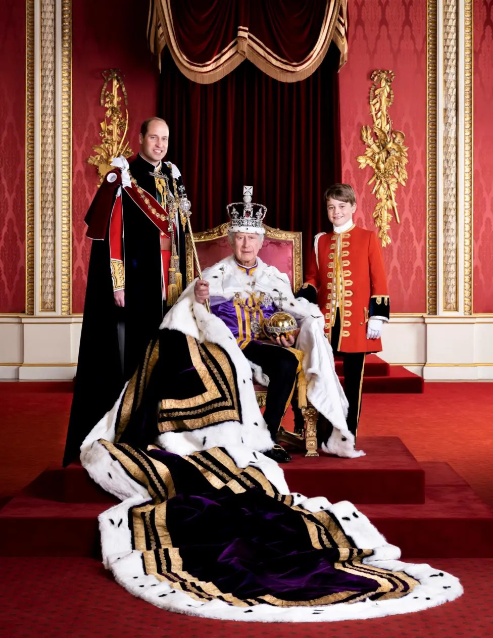 King Charles III in coronation robes with Prince William and Prince George in a formal palace portrait