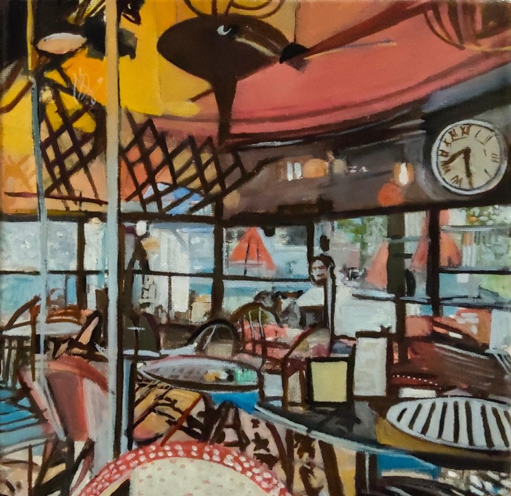Painted cafe interior with checkered tables, chairs, hanging fan and clock in warm colors