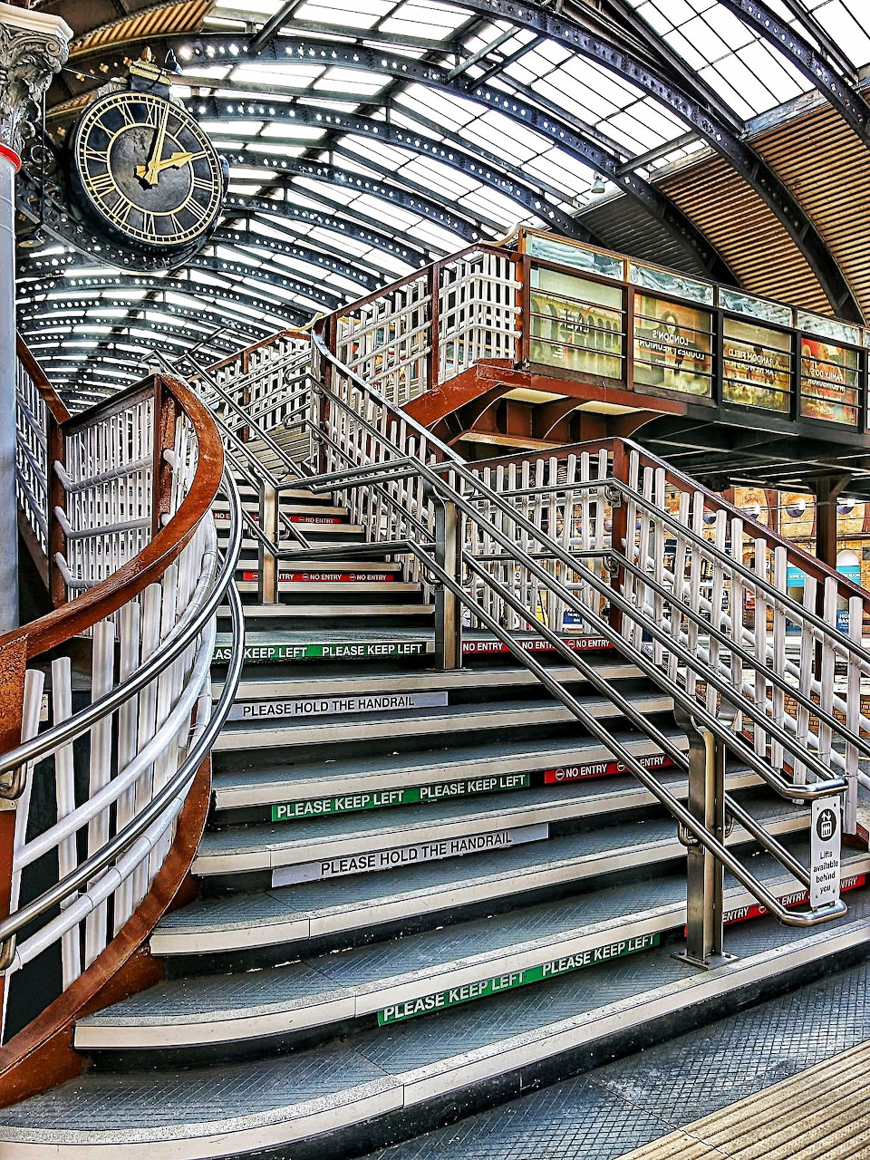 Curved staircases inside York station under an arched glass roof