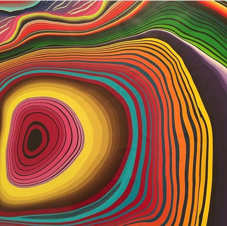 Abstract art with colorful concentric swirling bands in rainbow gradient creating hypnotic optical illusion effect