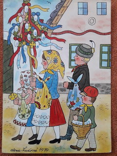 Folk art illustration showing family in traditional Czech dress around Christmas tree in village square