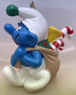 Blue Smurf Christmas ornament with Santa hat and candy cane on cloud base