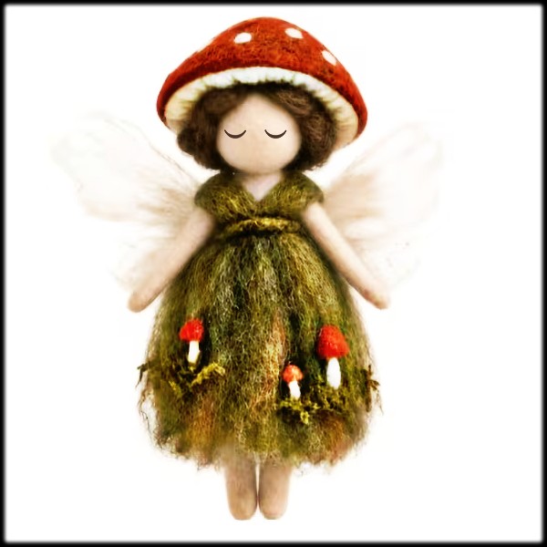 Handmade mushroom fairy doll with red cap, green dress, and translucent wings on white background