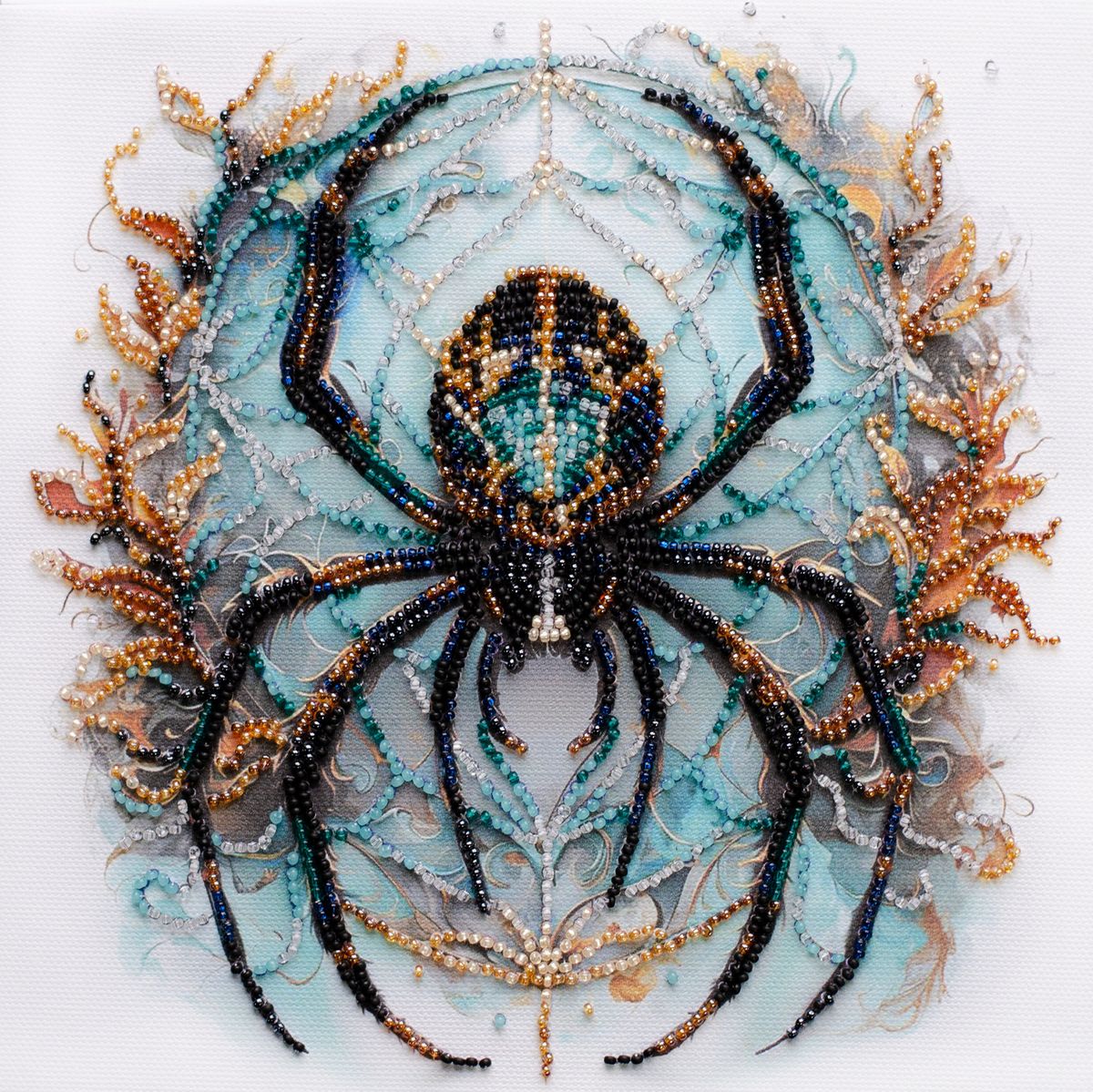 Decorative beaded spider with turquoise body and black legs, adorned with gold accents in symmetrical pattern
