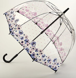 Transparent dome umbrella decorated with purple and pink flowers on a white background