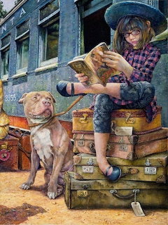 Girl in denim and hat reads book on vintage suitcases with brown pit bull dog, blue train car background