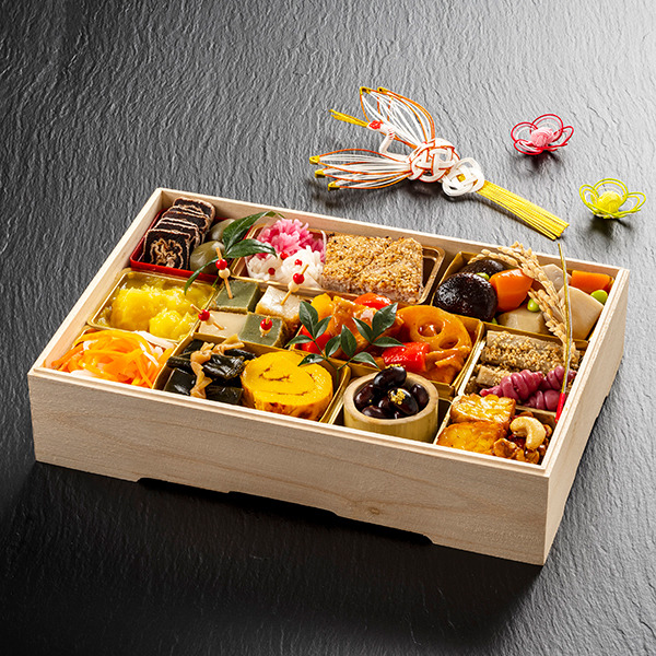 Traditional Japanese bento box with assorted colorful foods in wooden compartments