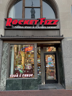 Rocket Fizz soda pop and candy shop storefront with glass door and display windows