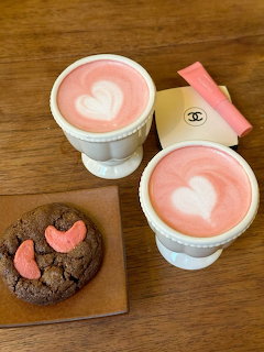 Valentine's Day coffee cup with pink ribbon and heart decorations