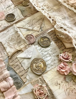 Vintage handwritten letters with wax seals, lace trim, and pink paper roses in a romantic flat lay