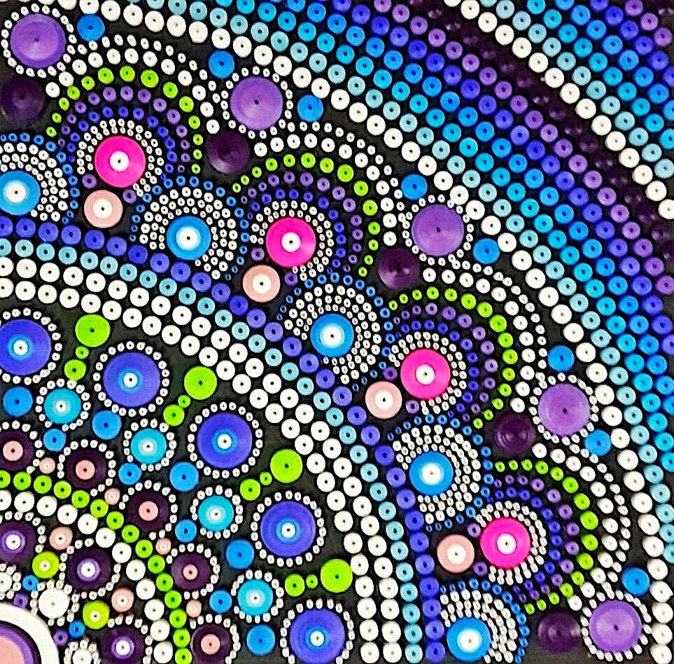 Colorful quarter mandala dot painting with concentric circles in blue, purple, pink, green, and white