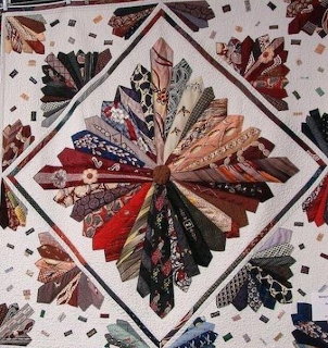 Patchwork quilt sewn from many colorful neckties in geometric arrangement