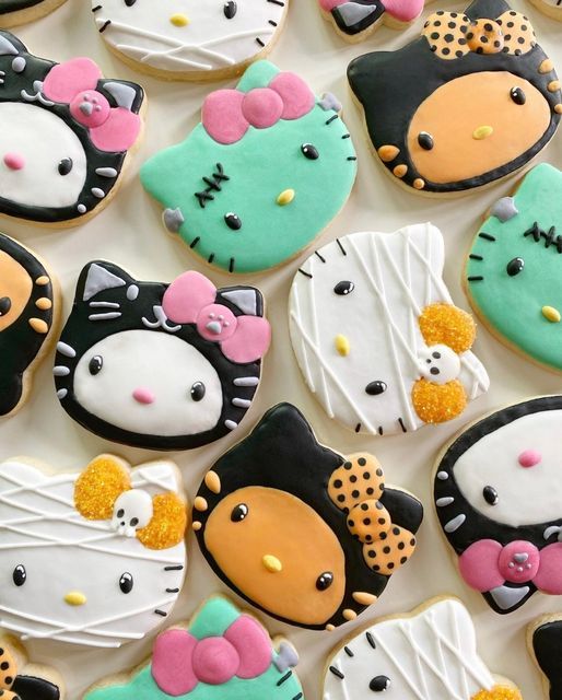 Assortment of colorful Halloween-themed decorated cookies on white surface