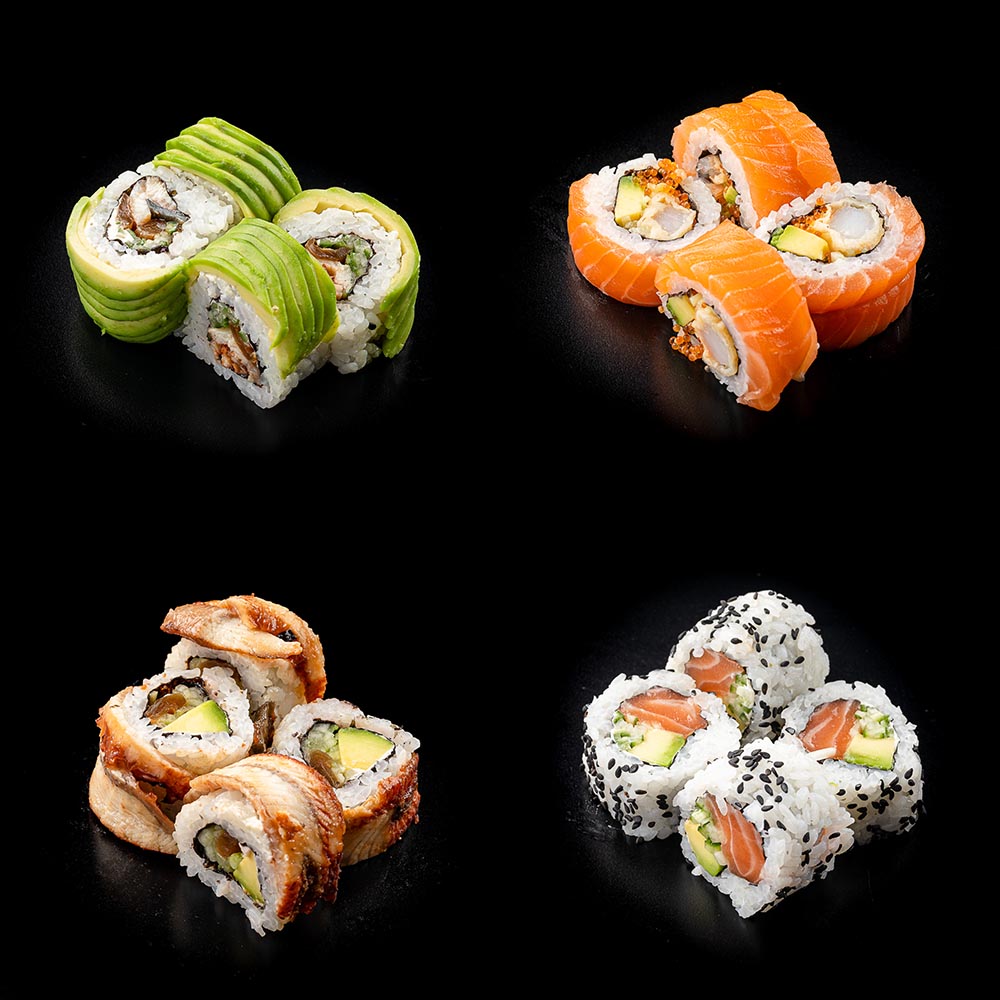 Four different sushi roll varieties arranged in groups on a black background