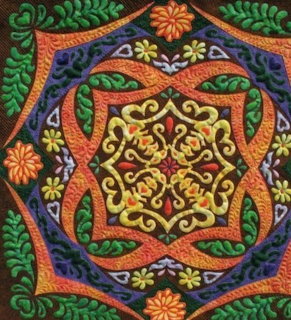 Close-up of a patchwork quilt with stitched fabric squares in varied colors and patterns.