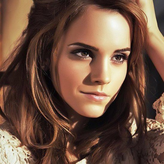 Portrait of a woman with brown wavy hair and subtle makeup in natural lighting