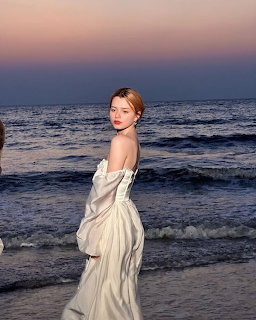 Woman in White Dress at Beach Sunset