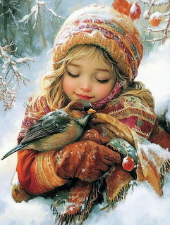 Girl in knit hat and scarf tenderly holding a small bird in winter snow