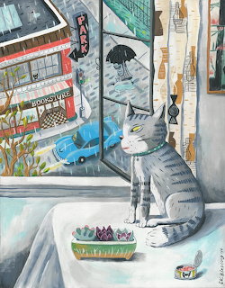 Gray striped cat sitting by window overlooking rainy urban street with cars and buildings