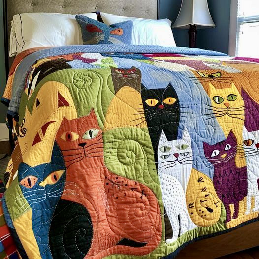 Patchwork quilt with colorful cat appliqués on bed with pillows and lamp