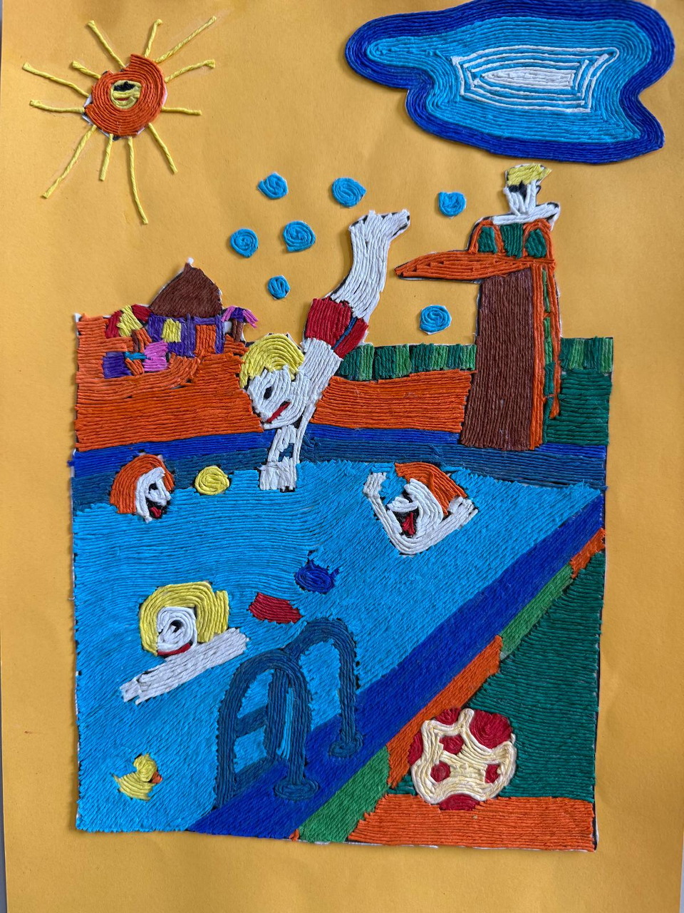 Child's artwork showing kids swimming in a blue pool with a sun, buildings, and colorful figures