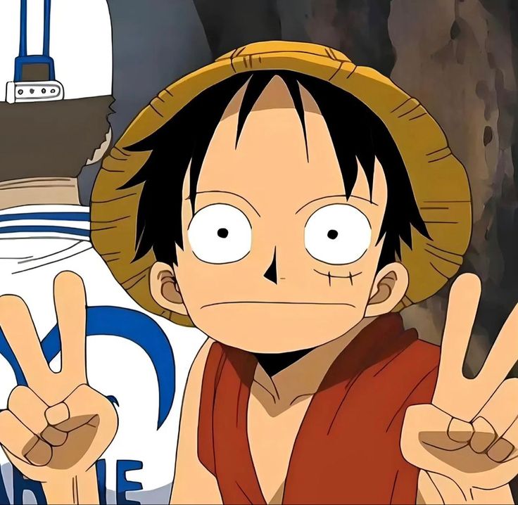 Luffy from One Piece anime smiling and making peace signs with both hands while wearing his straw hat