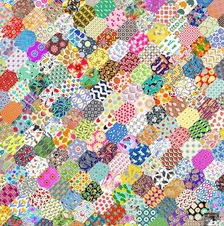 Colorful hexagonal patchwork quilt with diverse fabric patterns including flowers, dots, stripes and geometric shapes
