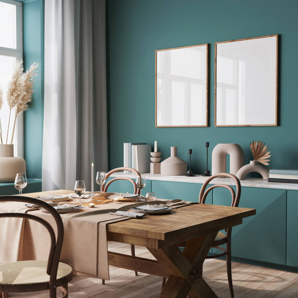 Modern dining room with wooden table, chairs, teal walls, and two framed mirrors