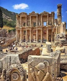 Ancient Library of Celsus at Ephesus, Turkey, with Roman columns and carved stone ruins in the foreground