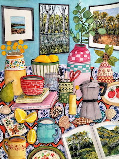 Colorful assortment of decorated teapots, cups, plates and kitchen items stacked on shelves with framed pictures