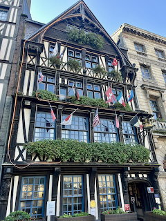 Black and white Tudor half-timbered building with flowers in Rouen