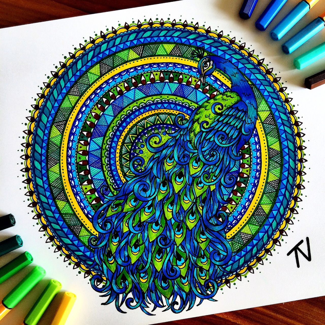 Colorful mandala drawing of a peacock with elaborate tail feathers surrounded by decorative circular patterns