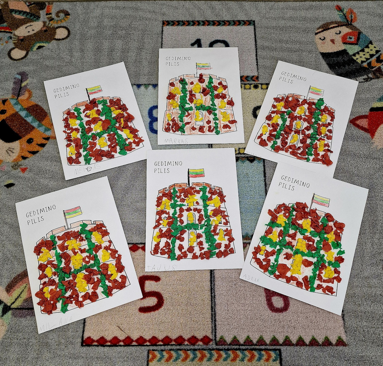 Six white cards with colorful abstract designs laid out on patterned fabric