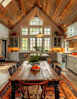 Rustic farmhouse kitchen with vaulted wood ceiling, gray cabinets, large windows, and long wooden dining table