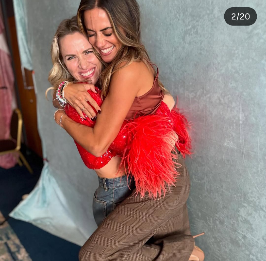 Two Women Hugging in Red Outfits
